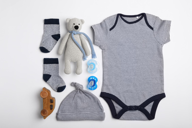 Photo of Flat lay composition with child's clothes and toys on white background