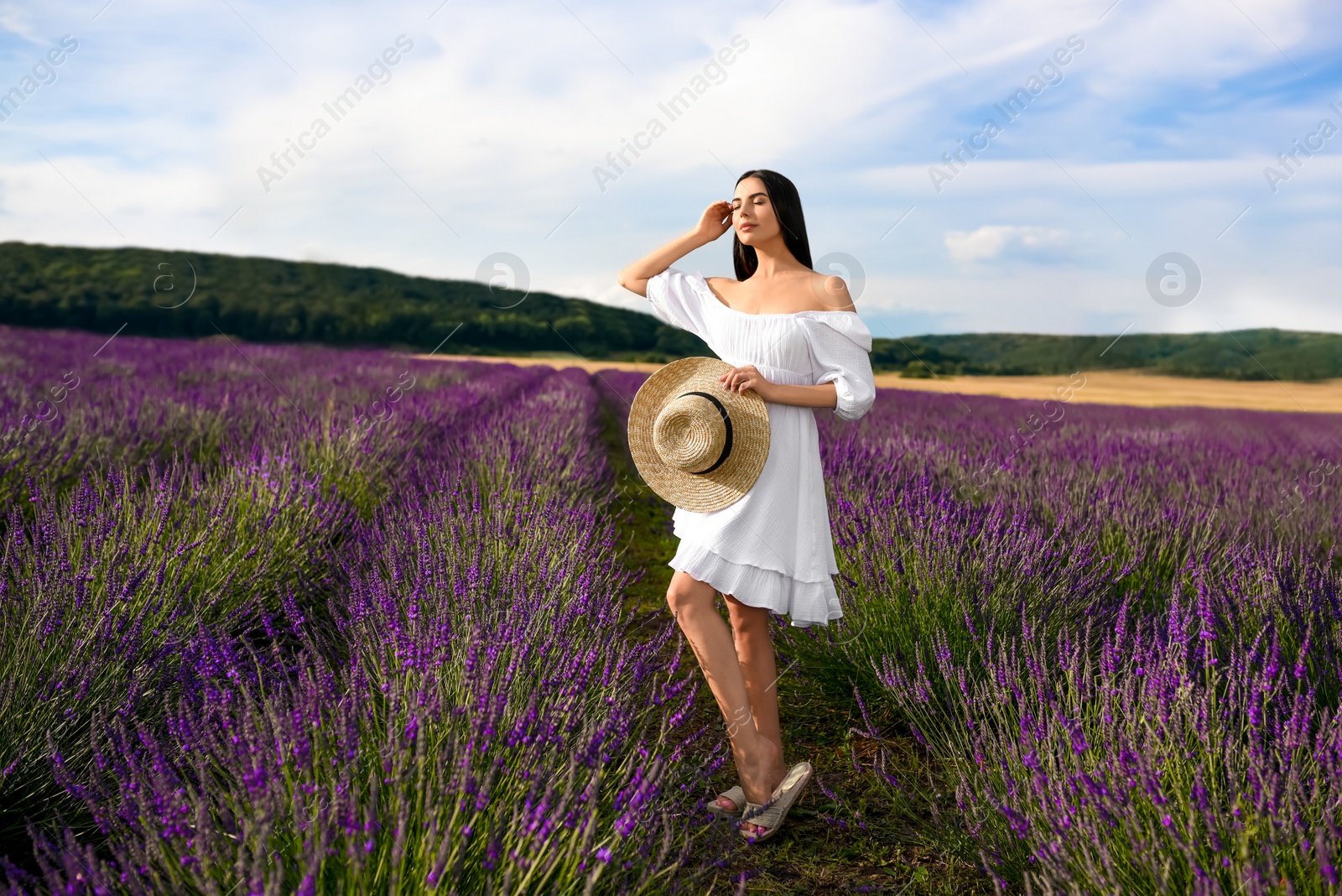 Photo of Beautiful young woman walking in lavender field