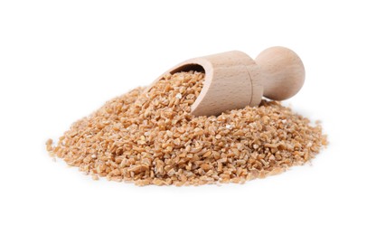 Photo of Pile of dry wheat groats and scoop isolated on white