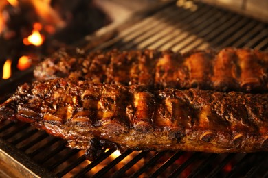 Grilling grate with tasty pork ribs in oven, closeup