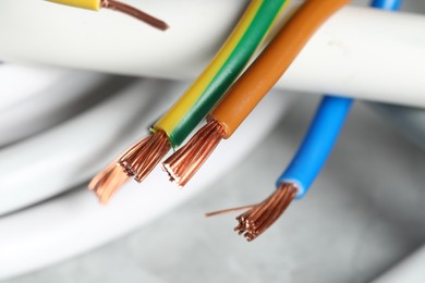 Photo of Colorful electrical wires on blurred background, closeup