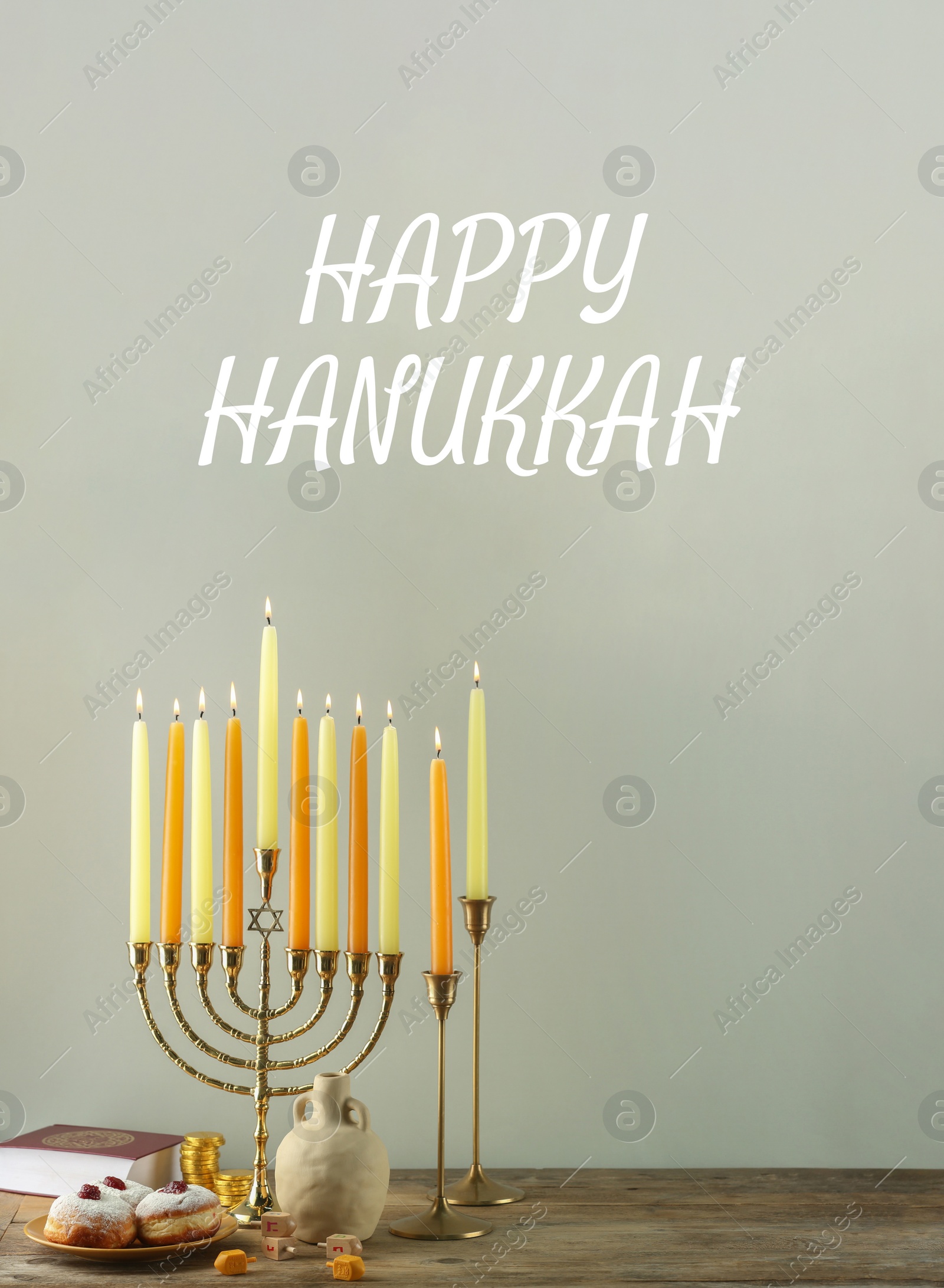 Image of Happy Hanukkah. Menorah, donuts and dreidels on wooden table