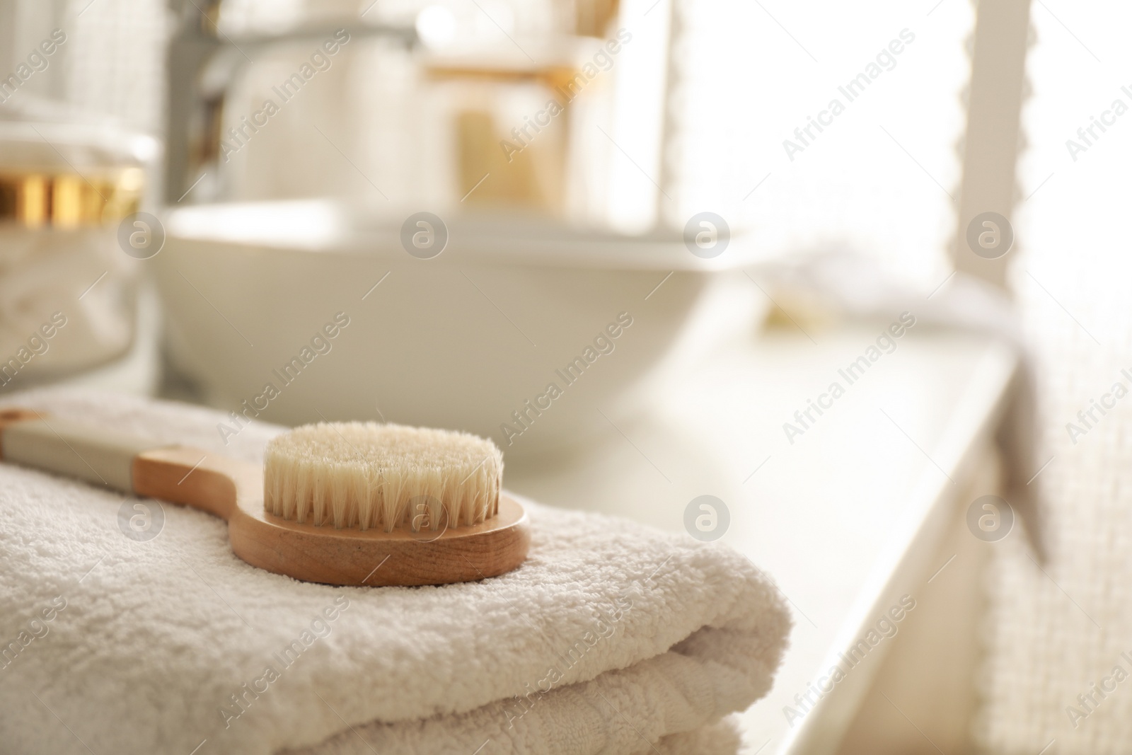 Photo of Hairbrush on towel on countertop in bathroom