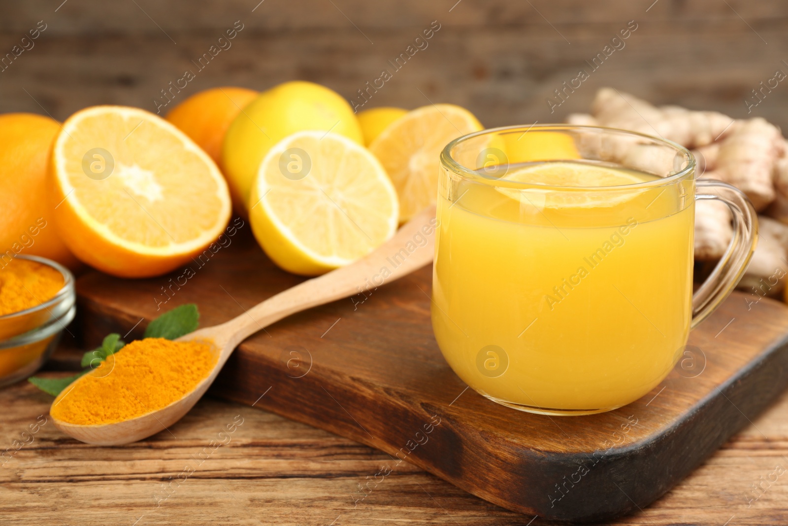 Photo of Immunity boosting drink and ingredients on wooden table