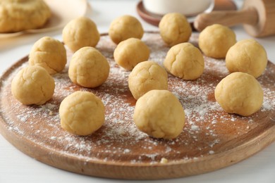 Photo of Shortcrust pastry. Raw dough balls on white table, closeup