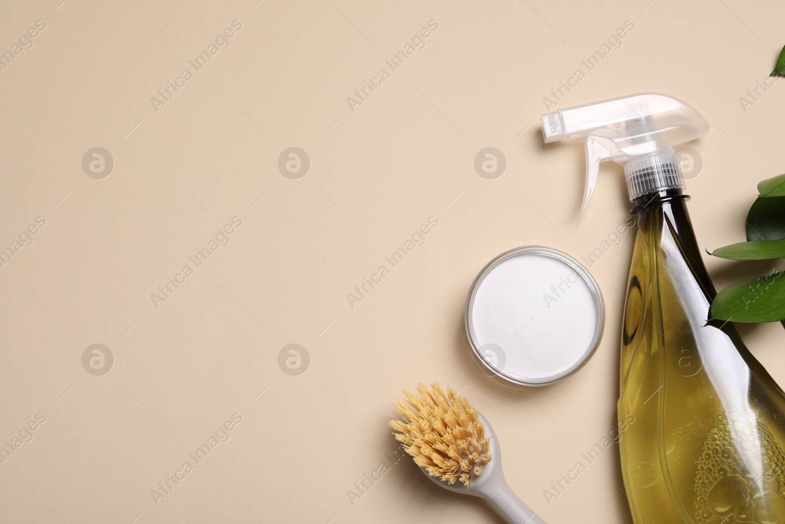 Photo of Bottle of cleaning product, brush and baking soda on beige background, flat lay. Space for text