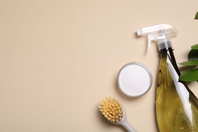 Photo of Bottle of cleaning product, brush and baking soda on beige background, flat lay. Space for text