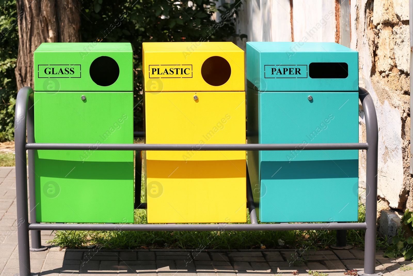 Photo of Waste sorting bins on city street. Recycling concept