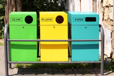 Photo of Waste sorting bins on city street. Recycling concept