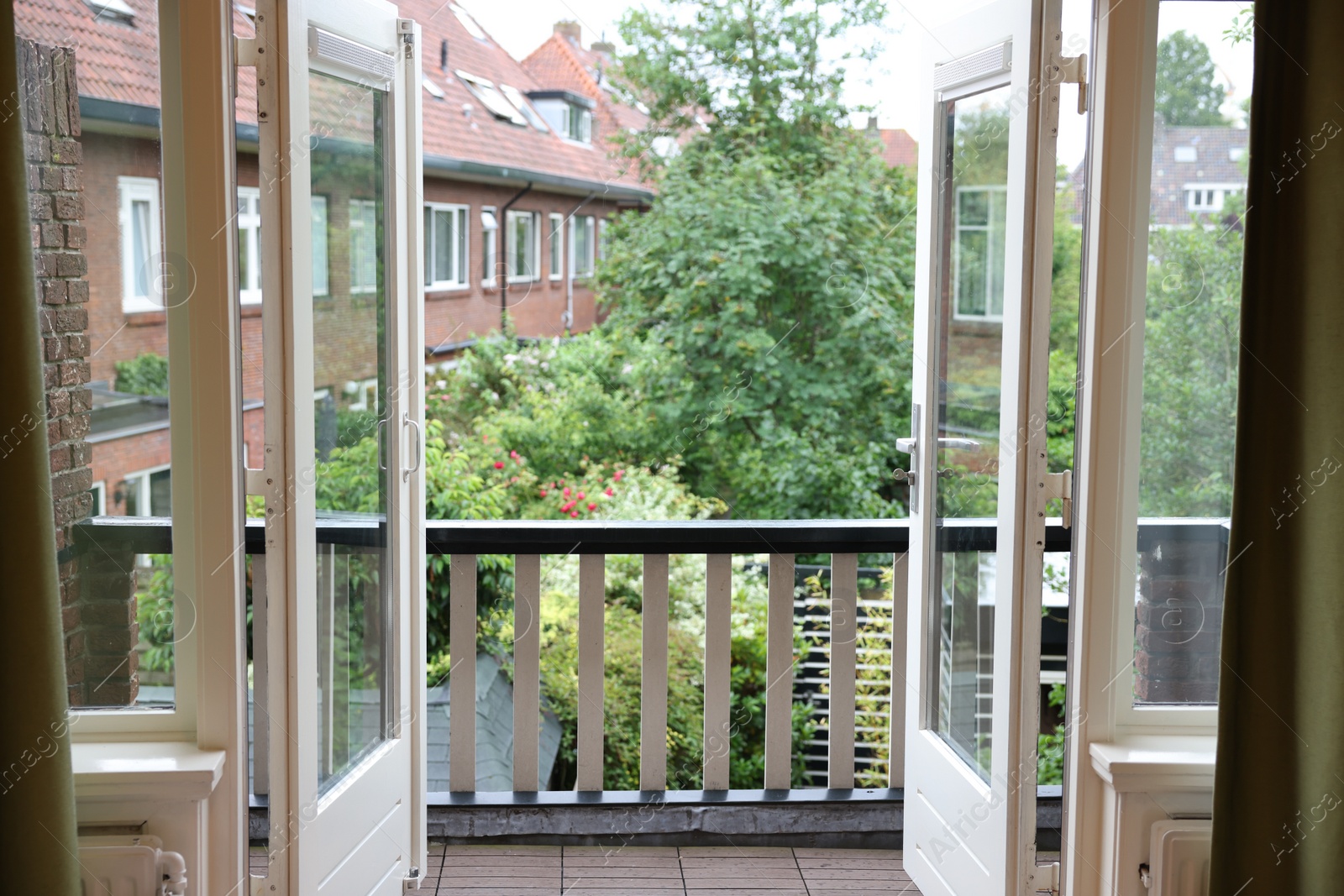 Photo of Beautiful view on balcony and inner yard with green trees from apartment