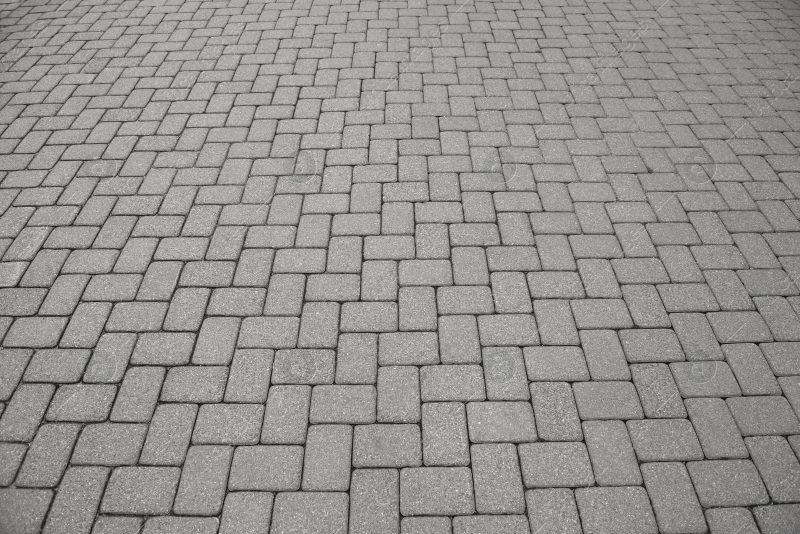 Photo of View on empty stone sidewalk. Footpath covering