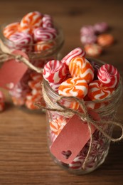 Photo of Colorful hard candies on wooden table, closeup