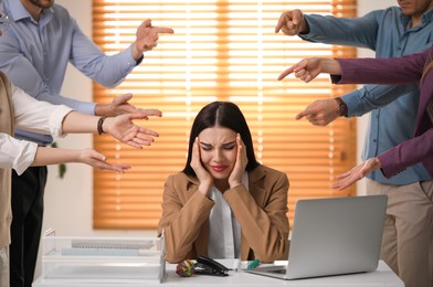 Photo of Coworkers bullying their colleague at workplace in office, closeup