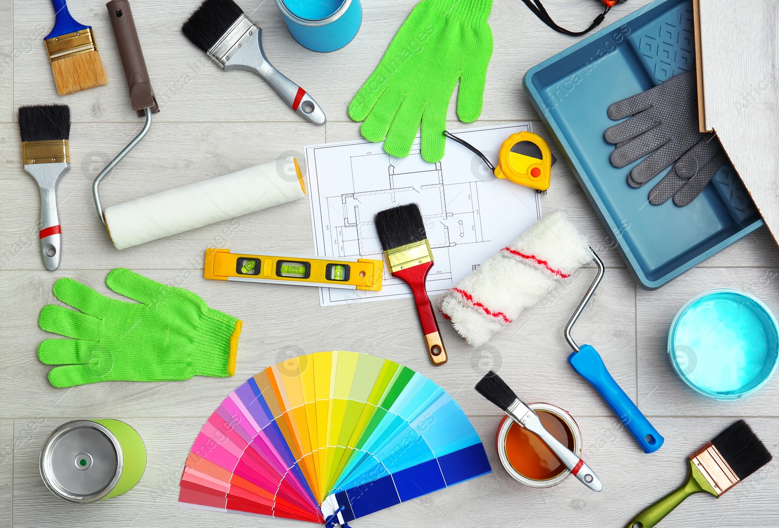 Photo of Set of decorator's tools on wooden floor