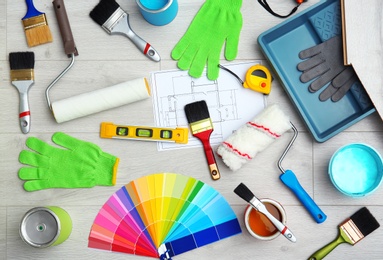 Set of decorator's tools on wooden floor