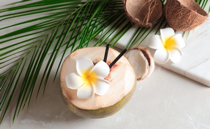 Photo of Beautiful composition with fresh green coconut on table