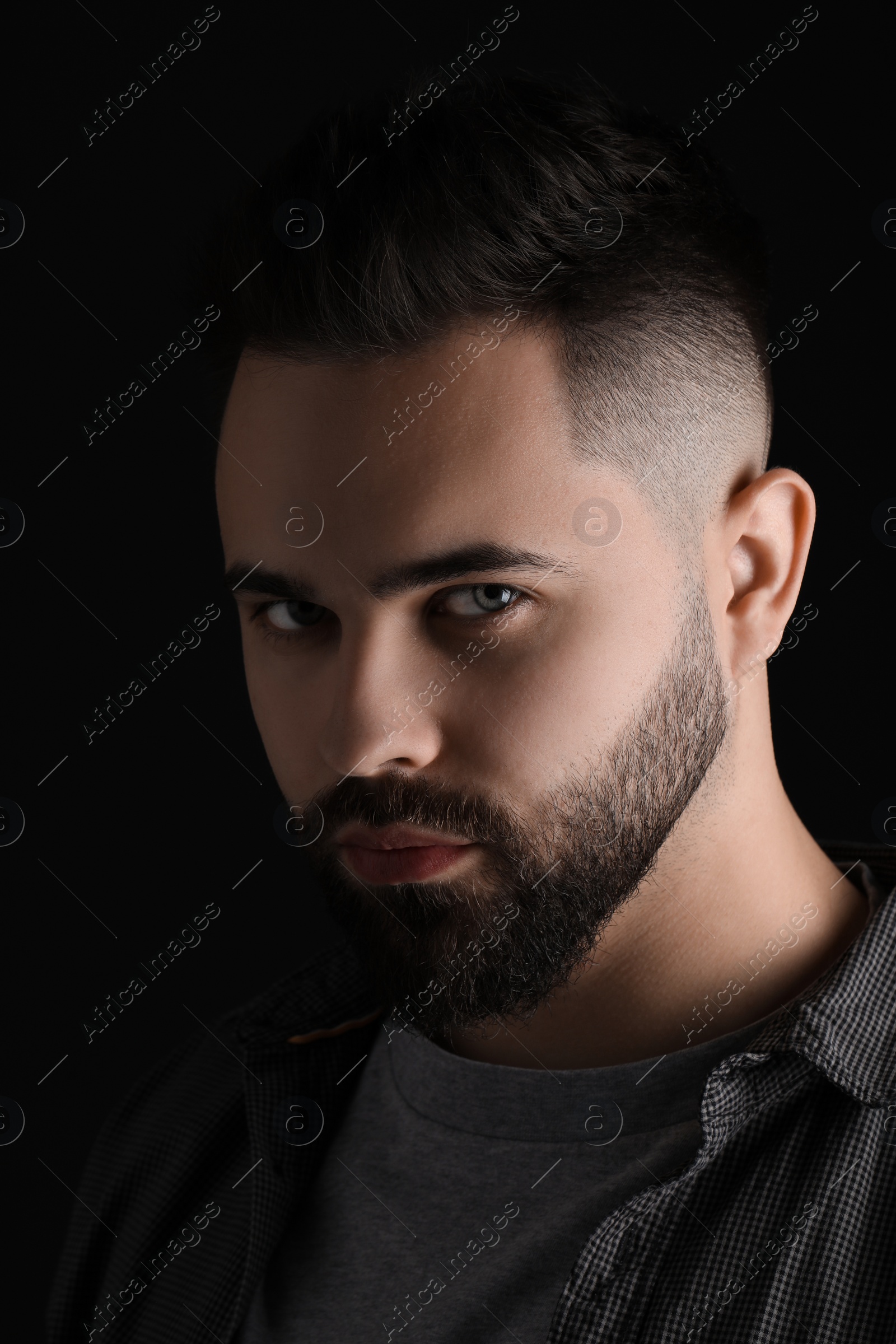 Photo of Evil eye. Man with scary eyes on black background