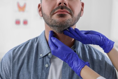 Endocrinologist examining thyroid gland of patient at hospital, closeup