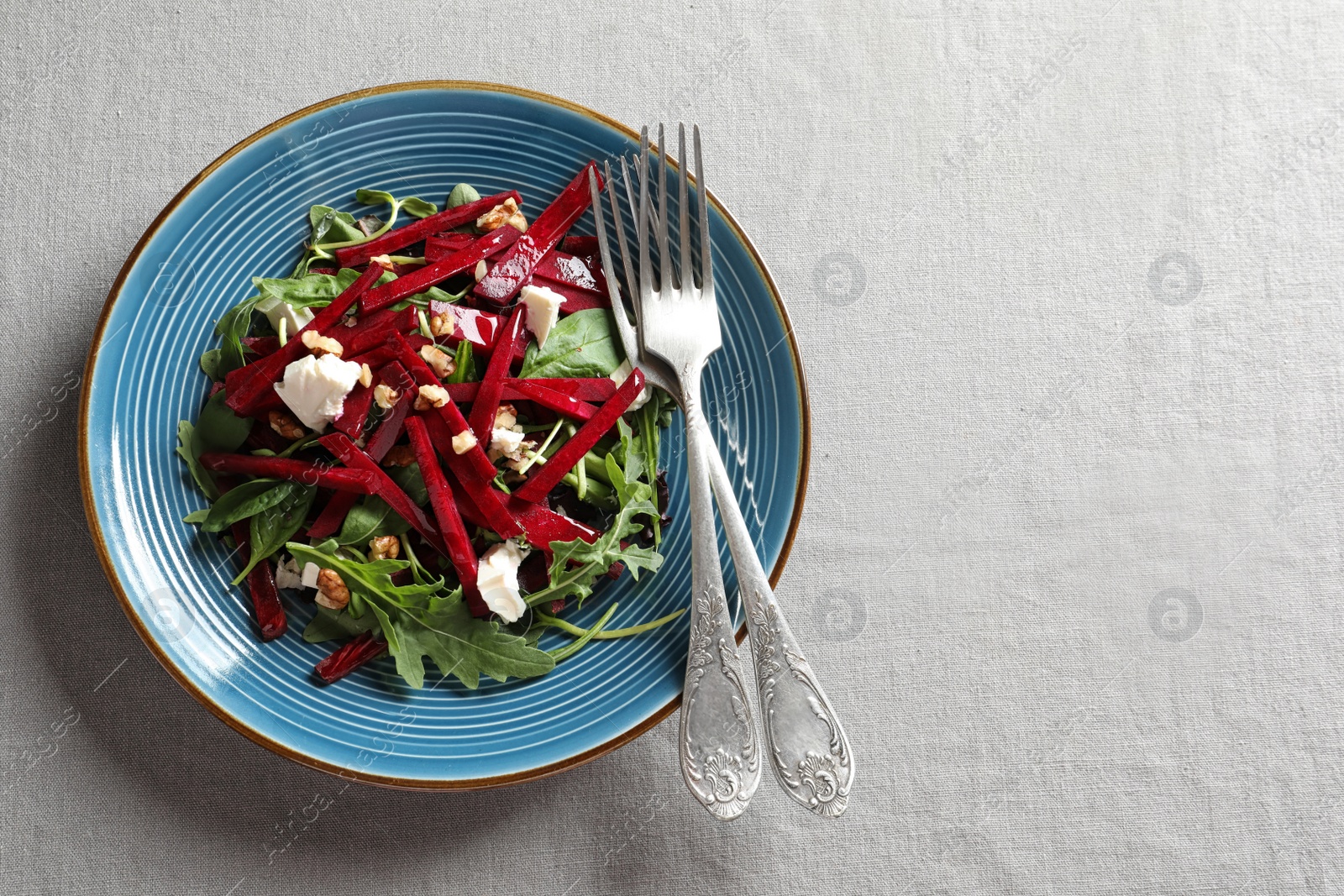 Photo of Plate with delicious beet salad on grey background, top view