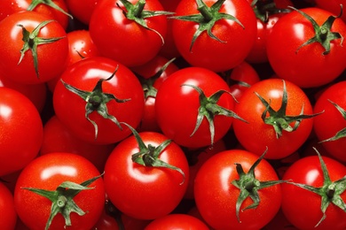 Photo of Delicious ripe cherry tomatoes as background, top view