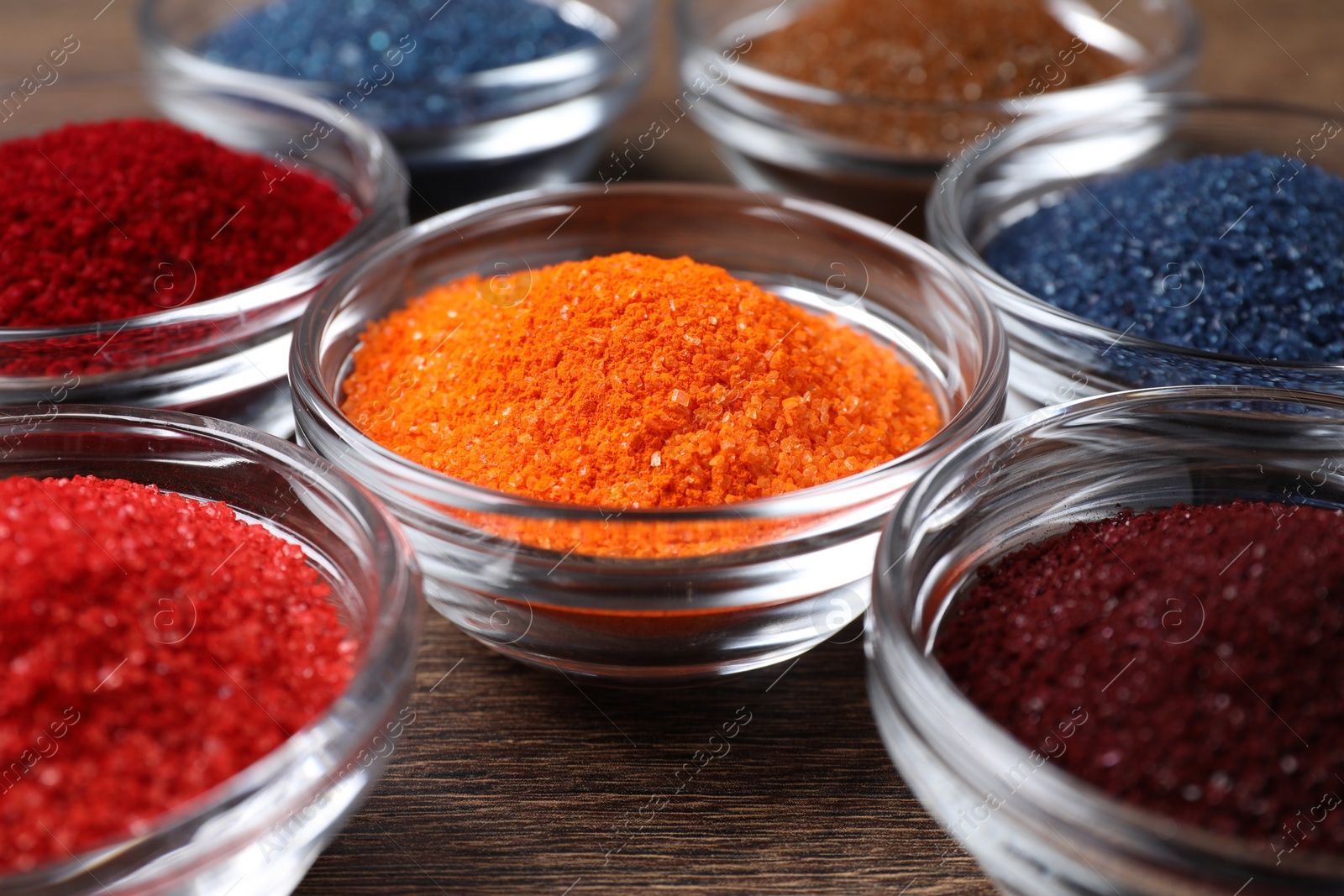 Photo of Many different food coloring on wooden table, closeup