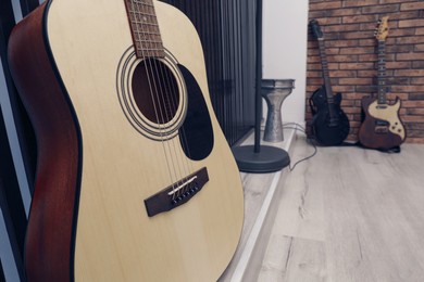 Different musical instruments indoors, focus on classical guitar