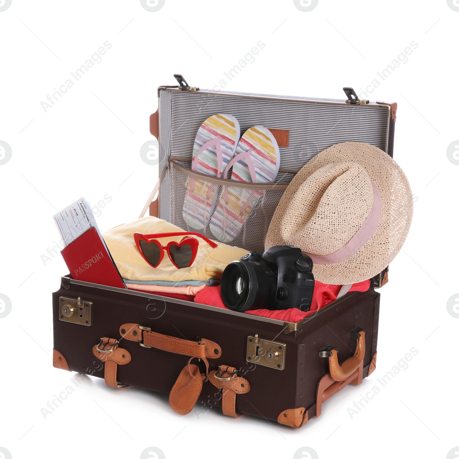 Photo of Open vintage suitcase with clothes packed for summer vacation isolated on white