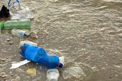 Photo of Beach polluted with plastic garbage. Ecological problem