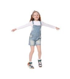 Photo of Cute little girl dancing on white background