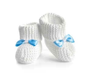 Handmade baby booties with bows isolated on white