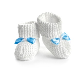 Photo of Handmade baby booties with bows isolated on white