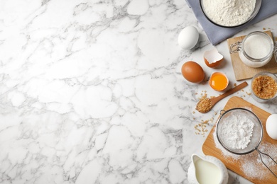 Photo of Flat lay composition with fresh ingredients for delicious homemade cake on white marble table. Space for text