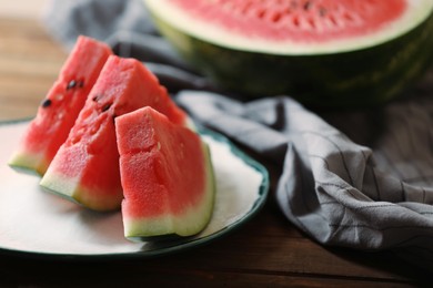 Photo of Sliced fresh juicy watermelon on wooden table, closeup. Space for text