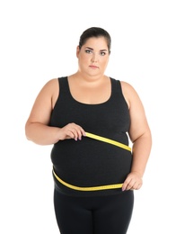 Overweight woman with measuring tape on white background