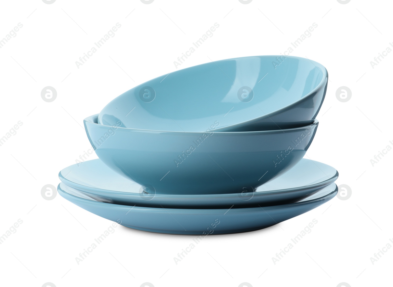 Photo of Stack of clean plates and bowls on white background