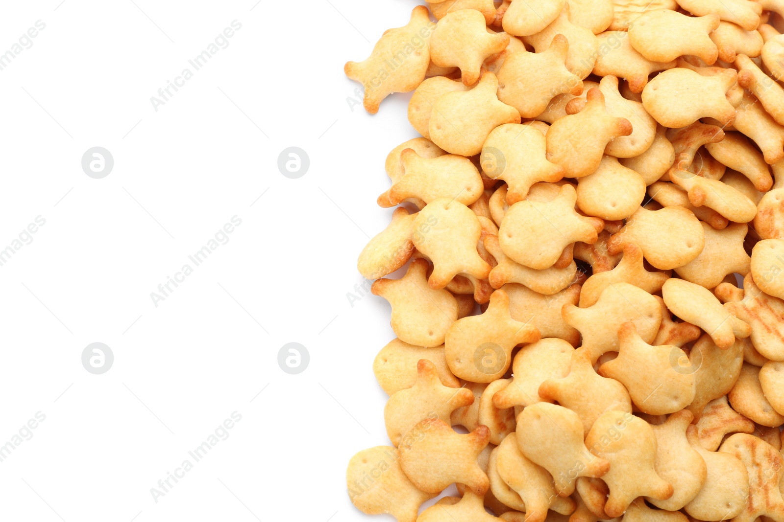 Photo of Delicious crispy goldfish crackers on white background, top view