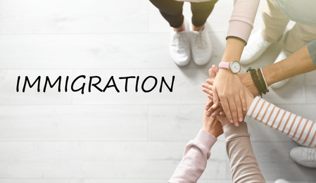 Image of Immigration concept. People holding hands together, top view