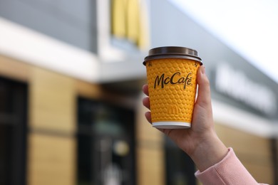 Photo of Lviv, Ukraine - September 26, 2023: Woman with hot McDonald's drink outdoors, closeup. Space for text