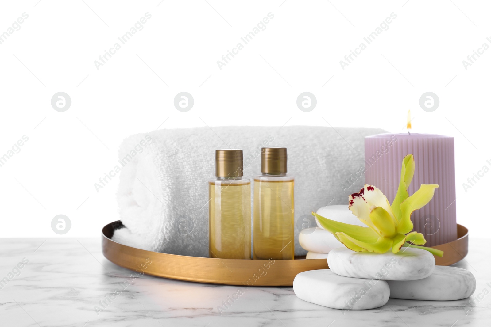 Photo of Composition with towel and spa supplies on marble table against white background