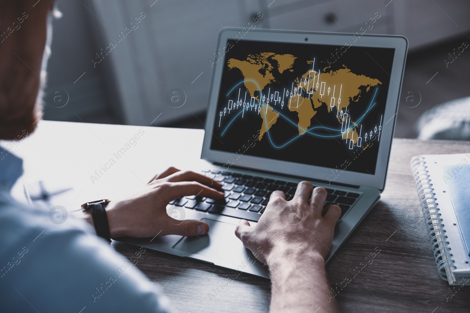 Image of Broker using laptop at table indoors, closeup. Forex trading