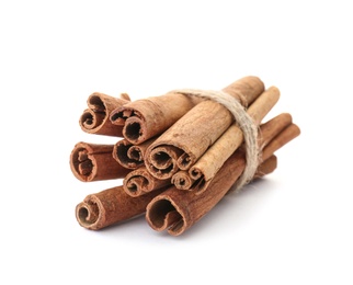 Photo of Tied cinnamon sticks on white background