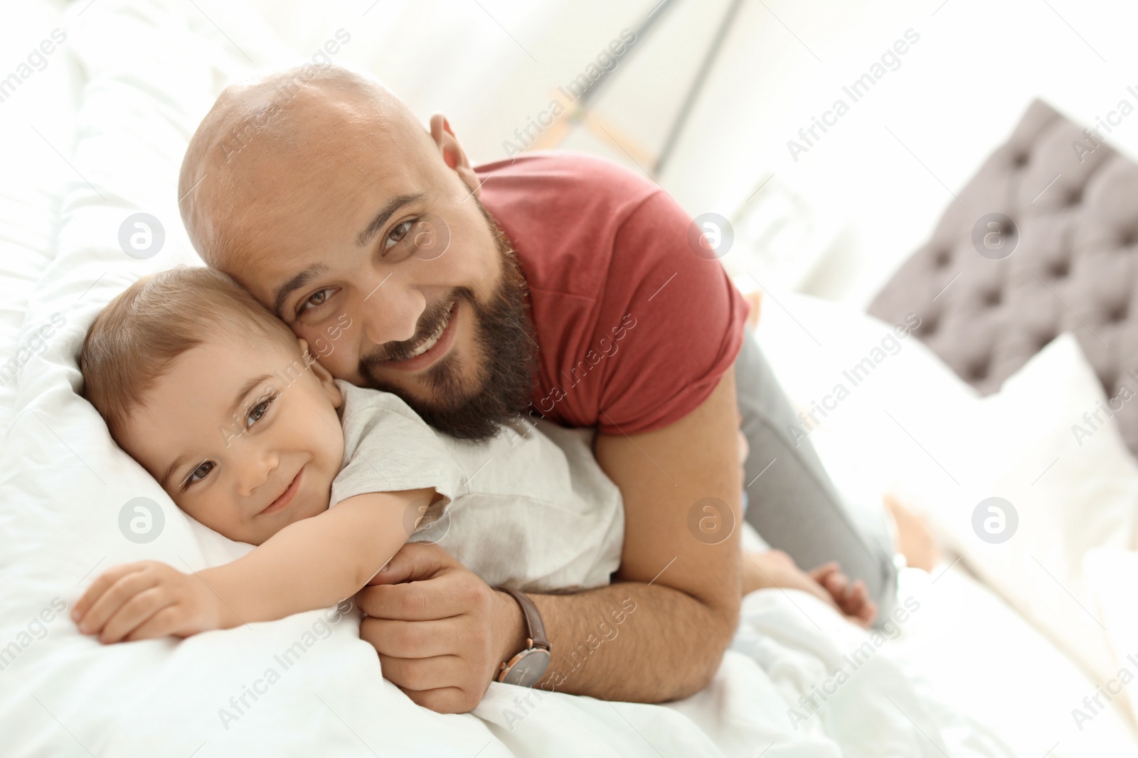 Photo of Dad and his little son spending time together at home