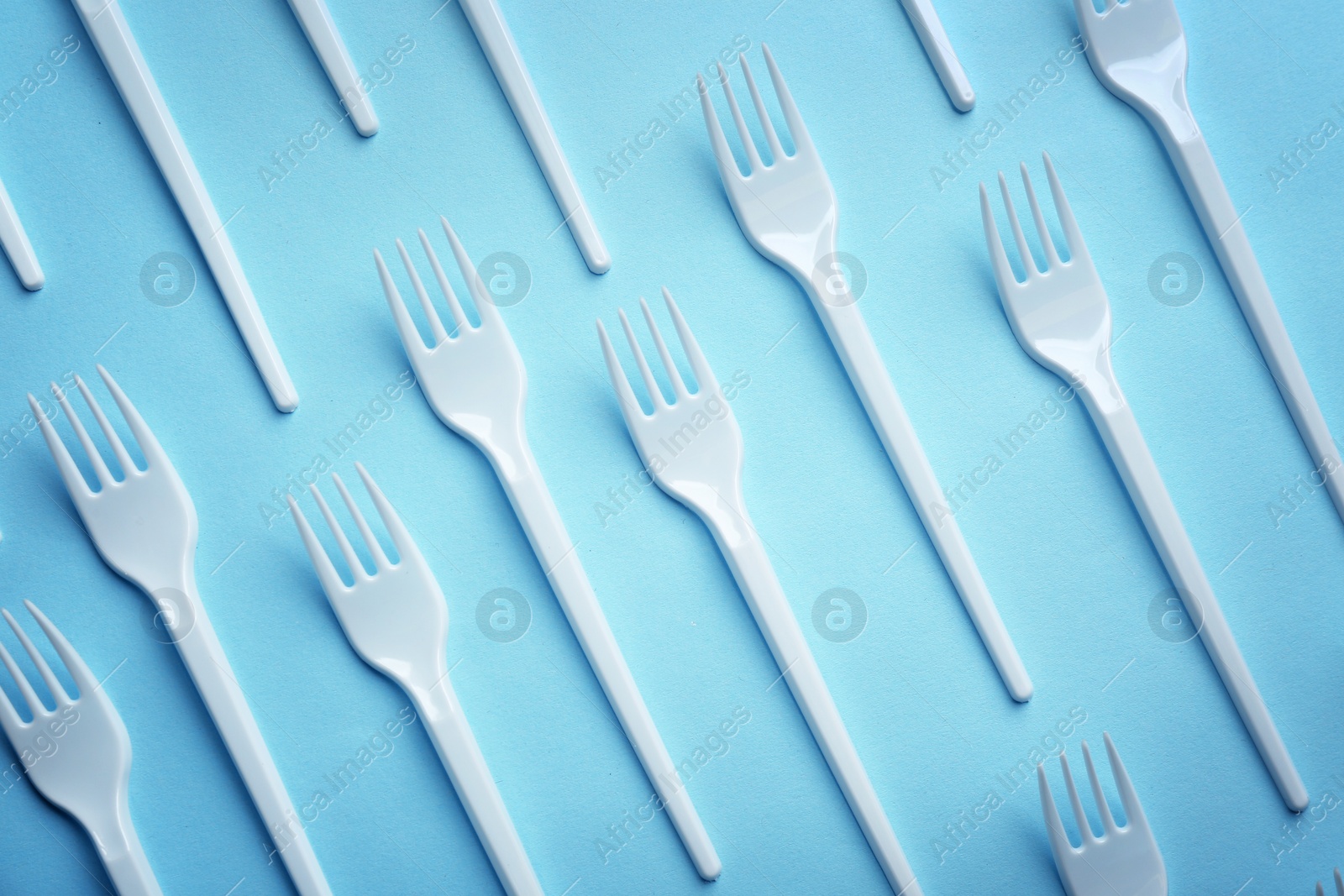 Photo of Flat lay composition with plastic forks on color background. Table setting