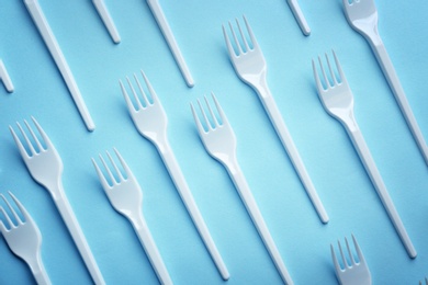 Flat lay composition with plastic forks on color background. Table setting