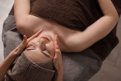 Photo of Spa therapy. Beautiful young woman lying on table during massage in salon