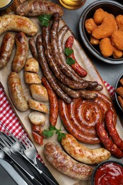 Photo of Set of different tasty snacks on dark grey table, flat lay