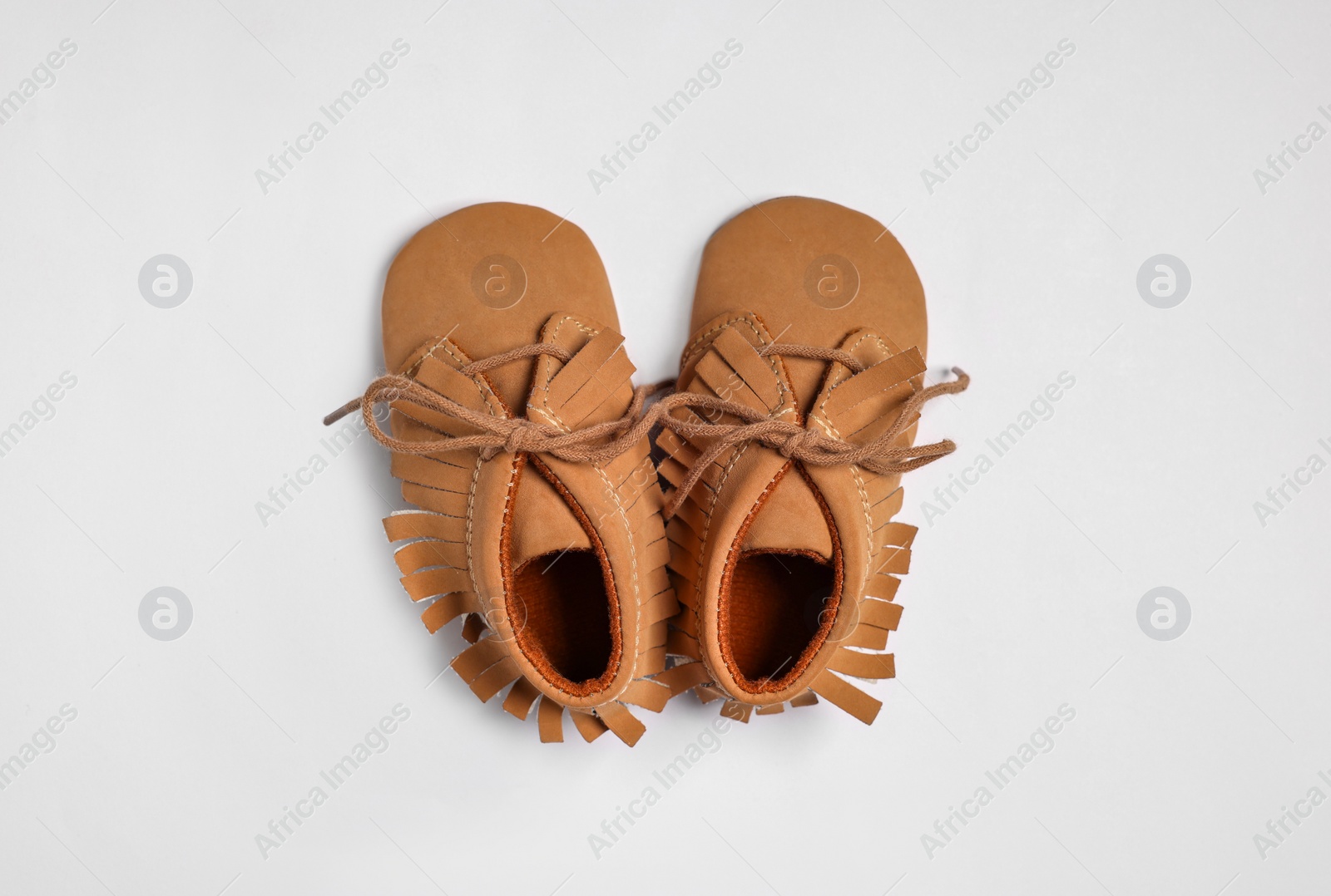 Photo of Cute baby shoes on white background, flat lay