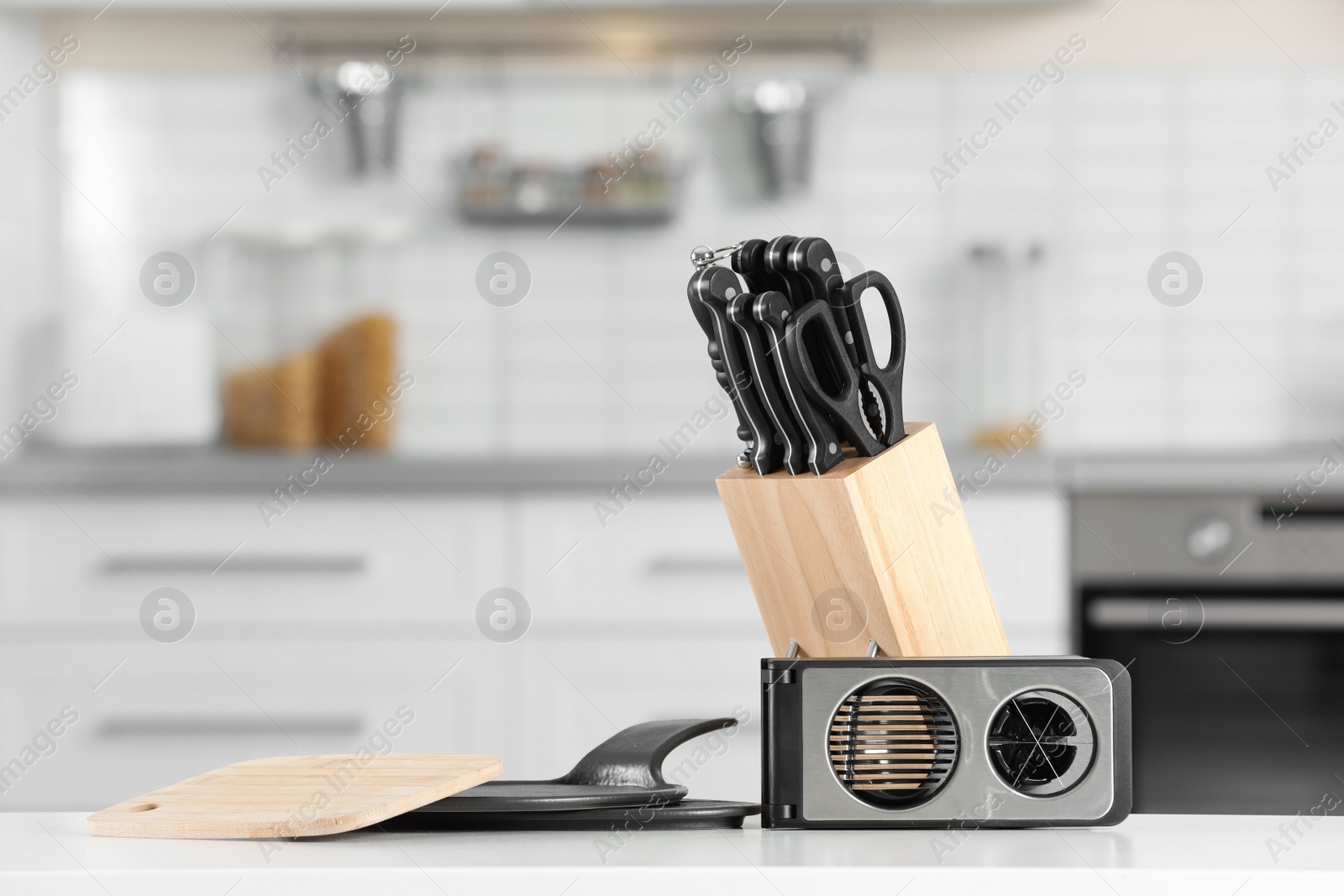 Photo of Set of clean utensils on table in kitchen. Space for text