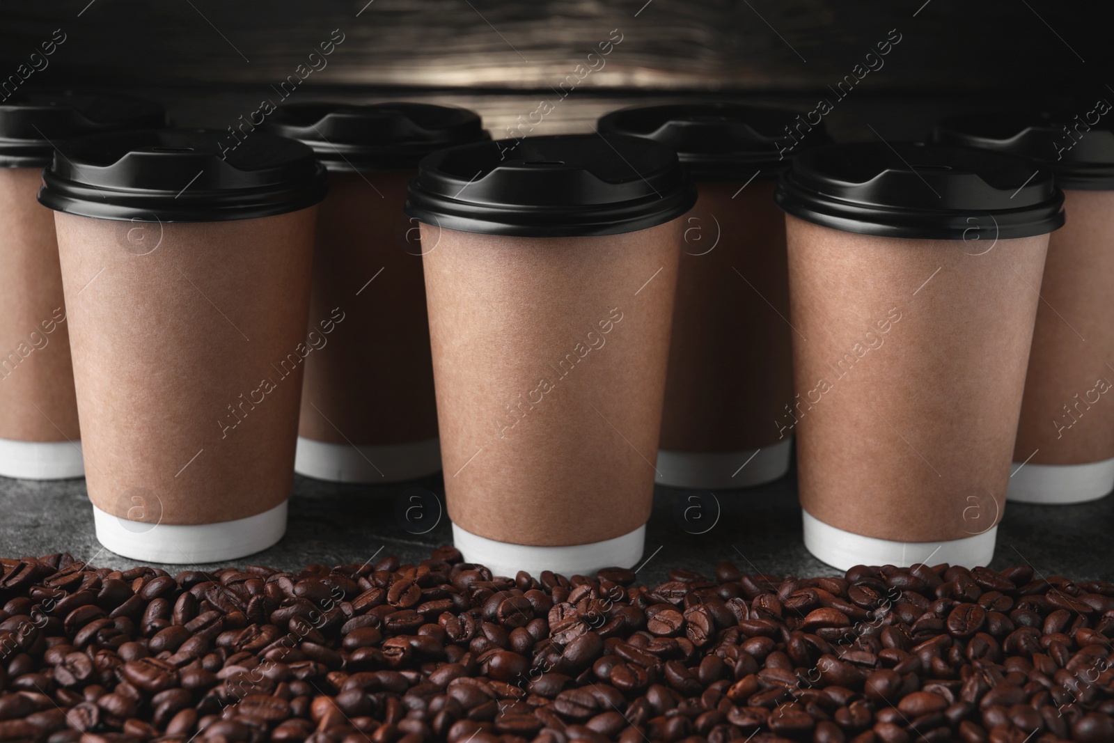 Photo of Coffee to go. Many paper cups and roasted beans on table