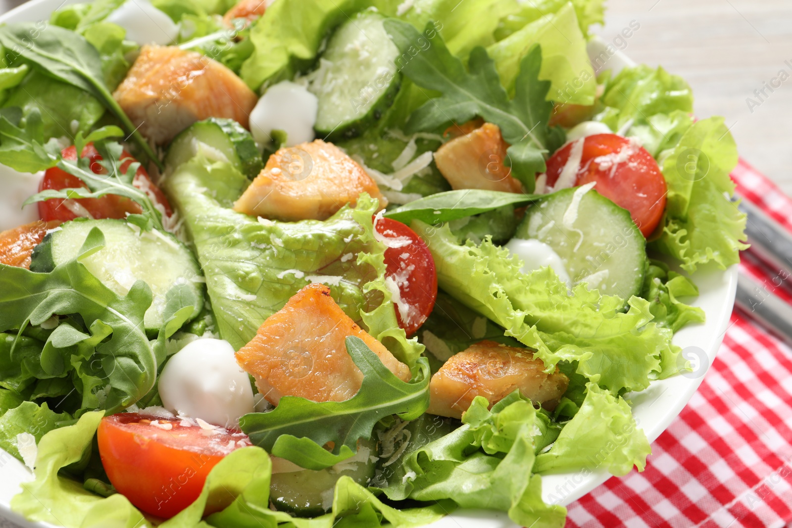 Photo of Delicious salad with chicken and vegetables on table, closeup